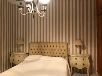 a bedroom with a bed and two night stands with lamps at Agradable Casa con maravillosas vistas in Chiva