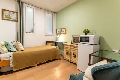 a bedroom with a bed and a lamp on a night stand at Mirador 2 del Mercado Central - habitacion con baño privado en el centro de la Ciudad Vella in Valencia