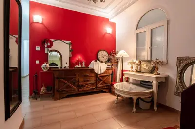 a bedroom with a bed and an orange wall at Mirador 2 del Mercado Central - habitacion con baño privado en el centro de la Ciudad Vella in Valencia