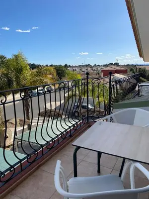 a table and chairs on a balcony with a view at Hostal Espai Mediterrani in Puebla de Vallbona
