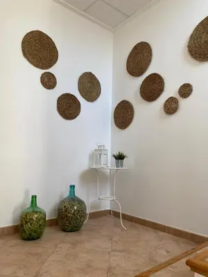 a room with a white wall with round decorations on the wall at Hostal Espai Mediterrani in Puebla de Vallbona