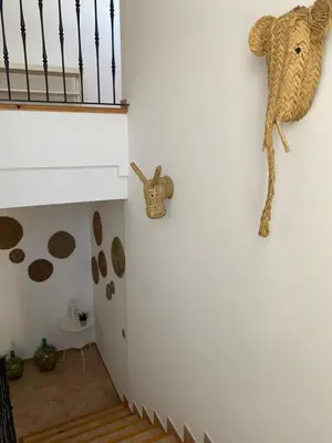 a room with a staircase and a stuffed animal on the wall at Hostal Espai Mediterrani in Puebla de Vallbona