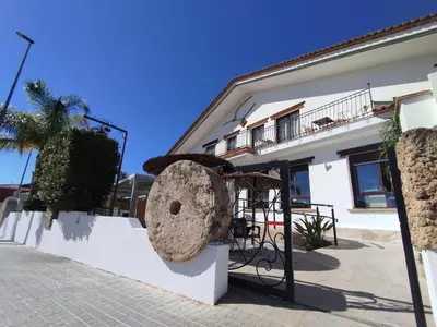 a large rock on the side of a building at Hostal Espai Mediterrani in Puebla de Vallbona