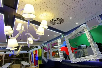 a store with lights on the ceiling and a mirror at Urban Youth Hostel in Valencia