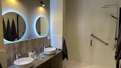 a bathroom with a sink and a mirror and a shower at Loft para 6 pax, 15 min de Ciencias y Artes y AC in Valencia