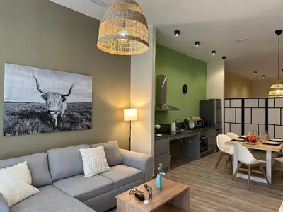a living room with a couch and a cow on the wall at Loft para 6 pax, 15 min de Ciencias y Artes y AC in Valencia
