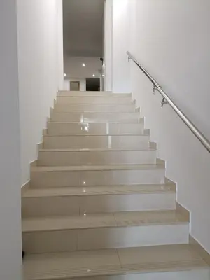 a staircase in a building with white walls and wooden stairs at MalvaLindaBeach Preciosa Casa Malvarrosa-Patacona in Valencia