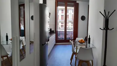 a kitchen and dining room with a table and a refrigerator at Reina in Valencia