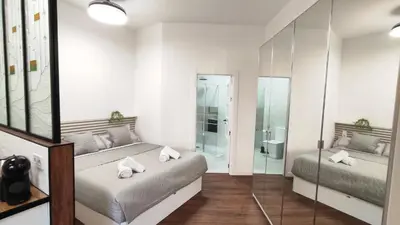 a bedroom with two beds and a walk in shower at Reina in Valencia