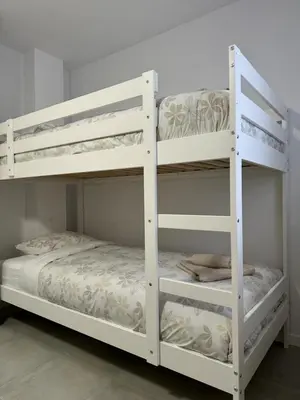 two white bunk beds in a room at UIM Mediterraneo Cendoya 3 Wifi in Puerto de Sagunto