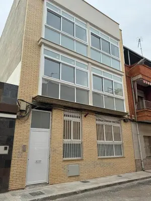 a brick building with white doors and windows at UIM Mediterraneo Cendoya 3 Wifi in Puerto de Sagunto