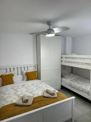 a bedroom with a bed with two bunk beds at UIM Mediterraneo Cendoya 4 Wifi in Puerto de Sagunto