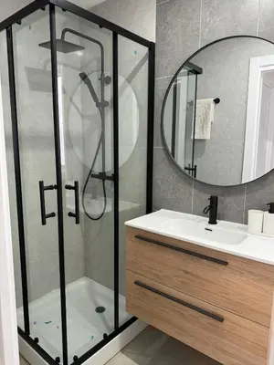 a bathroom with a shower and a sink and a mirror at UIM Mediterraneo Cendoya 5 Wifi in Puerto de Sagunto