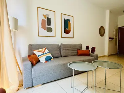 a living room with a couch and two glass tables at Stylish Apartment with Terrace on the BeachFrom in Valencia
