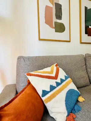 a couch with colorful pillows on top of it at Stylish Apartment with Terrace on the BeachFrom in Valencia