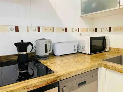 a kitchen counter with a microwave and a coffee maker at Stylish Apartment with Terrace on the BeachFrom in Valencia