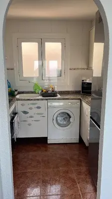 a kitchen with a washing machine in a kitchen at Ático El Faro Cullera in Faro de Cullera