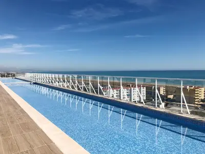 a swimming pool on the roof of a cruise ship at Global Vacacional, Moderno apartamento con piscina y terraza en la playa de Canet in Canet de Berenguer