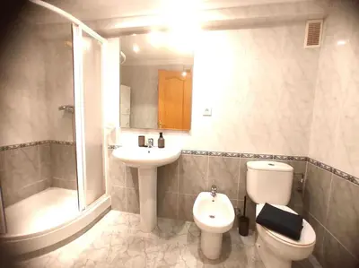 a bathroom with a toilet and a sink and a shower at Amanecer frente al mar in Valencia