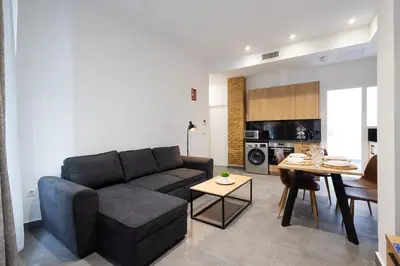 a living room with a couch and a table at FLORIT FLATS - The Patraix Apartments in Valencia
