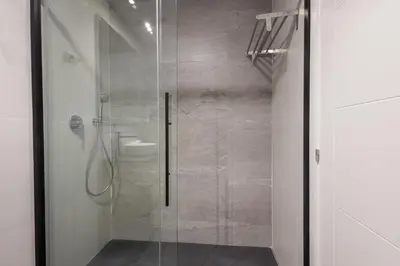 a shower with a glass door in a bathroom at FLORIT FLATS - The Patraix Apartments in Valencia