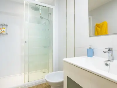 a white bathroom with a shower and a toilet at Apartment Orion-2 by Interhome in Cullera