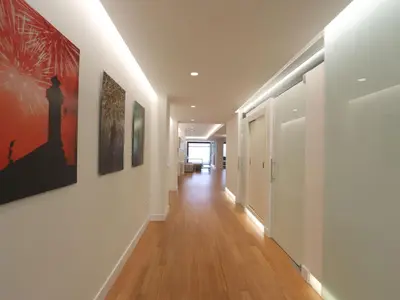 a hallway with white walls and paintings on the walls at Apartment Loft Villalonga by Interhome in Valencia