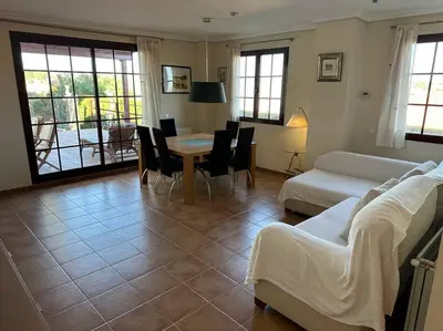 a living room with a couch and a table and chairs at Oasis en Riba Roja del Turia in Riba-Roja De Turia