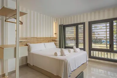a bedroom with a large white bed with white pillows at Gulliver Suites Valencia in Valencia