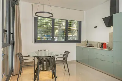 a dining room with a table and chairs in a kitchen at Gulliver Suites Valencia in Valencia