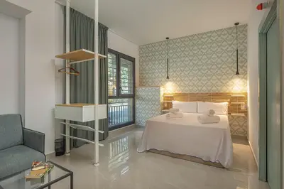 a bedroom with a bed with towels on it at Gulliver Suites Valencia in Valencia