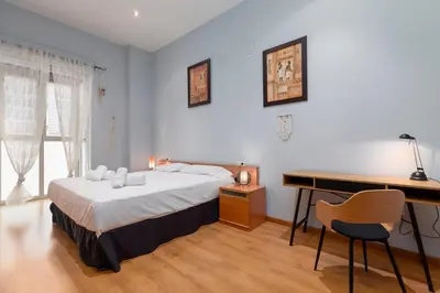 a bedroom with a bed and a desk and a desk at Patacona Mediterranean Beach in Valencia