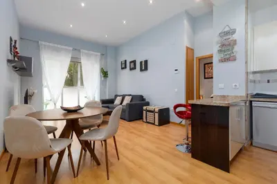 a kitchen and a living room with a table and chairs at Patacona Mediterranean Beach in Valencia