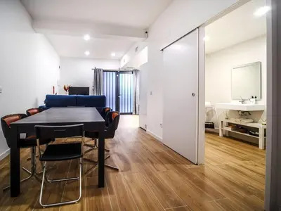 a dining room with a black table and a white room at Apartamento Disfrutones Valencia in Valencia