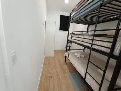 a room with two bunk beds and a television at Apartamento Disfrutones Valencia in Valencia