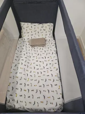a bed in a box with a blanket with dogs on it at Apartamento Disfrutones Valencia in Valencia