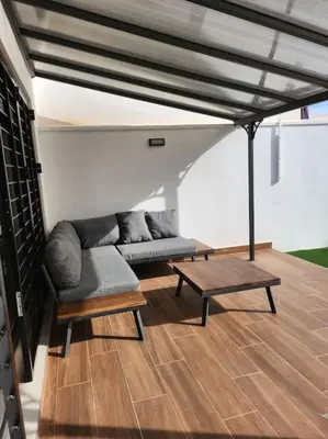 a living room with a couch and a coffee table at the butterfly house in Rafelbuñol