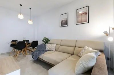 a living room with a couch and a table at the butterfly house in Rafelbuñol