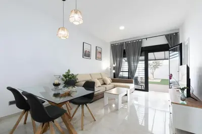 a living room with a couch and a table at the butterfly house in Rafelbuñol