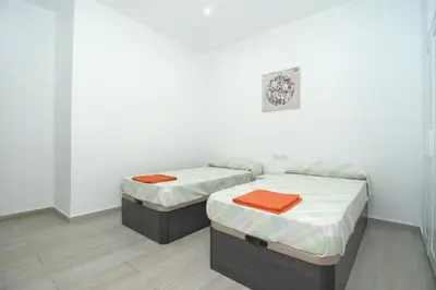 a hallway with white walls and a red couch at Bam ! Centro ! Centre ! Zentrum ! in Valencia