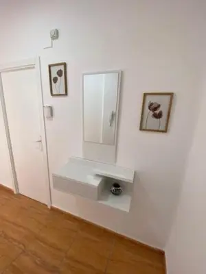 a bathroom with a sink and a mirror on a wall at Exclusivo Apartamento ALZIRA in Alzira