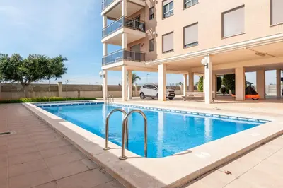 a swimming pool in front of a building at Burriana Beach Retreat: Pool & Comfort in Burriana