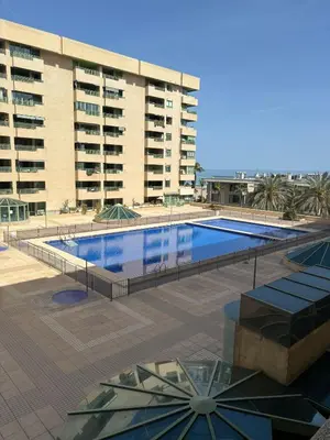 a large swimming pool in front of a building at Playa Patacona con vistas al mar in Valencia