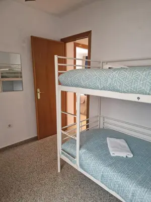 a couple of bunk beds in a room with a door at Playa Patacona con vistas al mar in Valencia