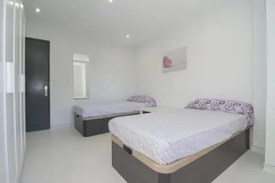 two beds in a white room with at Calm Company in Valencia