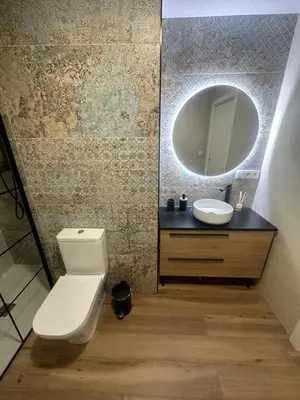 a bathroom with a toilet and a sink and a mirror at Beach Apartments Valencia 2 in Valencia