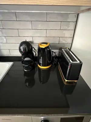 a black counter top with a toaster and a toaster at Beach Apartments Valencia 2 in Valencia