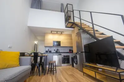 a living room with a couch and a staircase at Beach Apartments Valencia 2 in Valencia