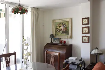 a dining room with a table and a painting on the wall at El Descans Solo Familias Serviplaya in Casas Las Basas