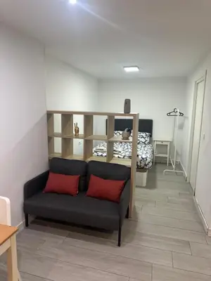 a living room with a couch and a bed at Precioso apartamento 2 personas in Valencia
